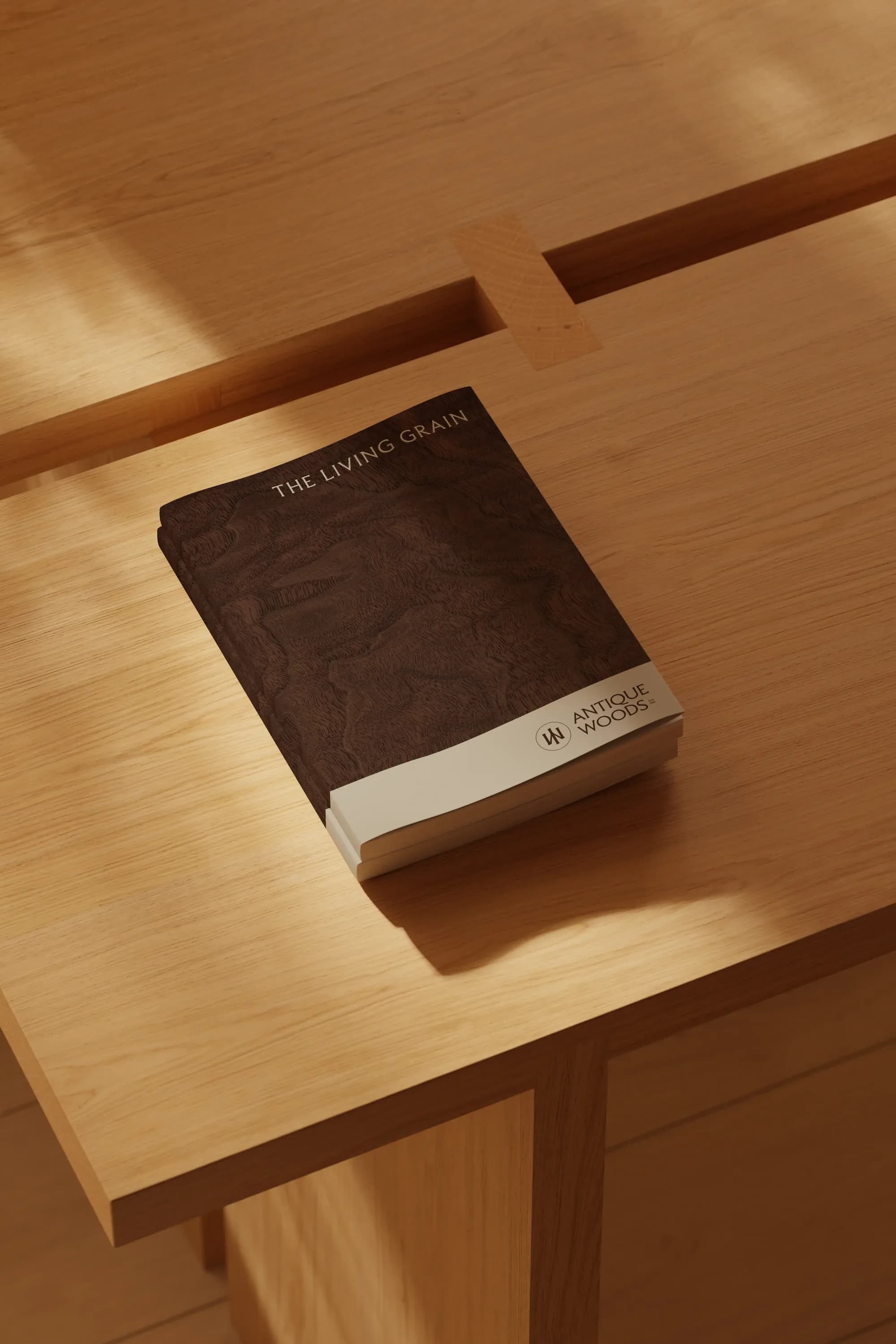 The Living Grain, the Antique Woods catalogue, lying on an oak table