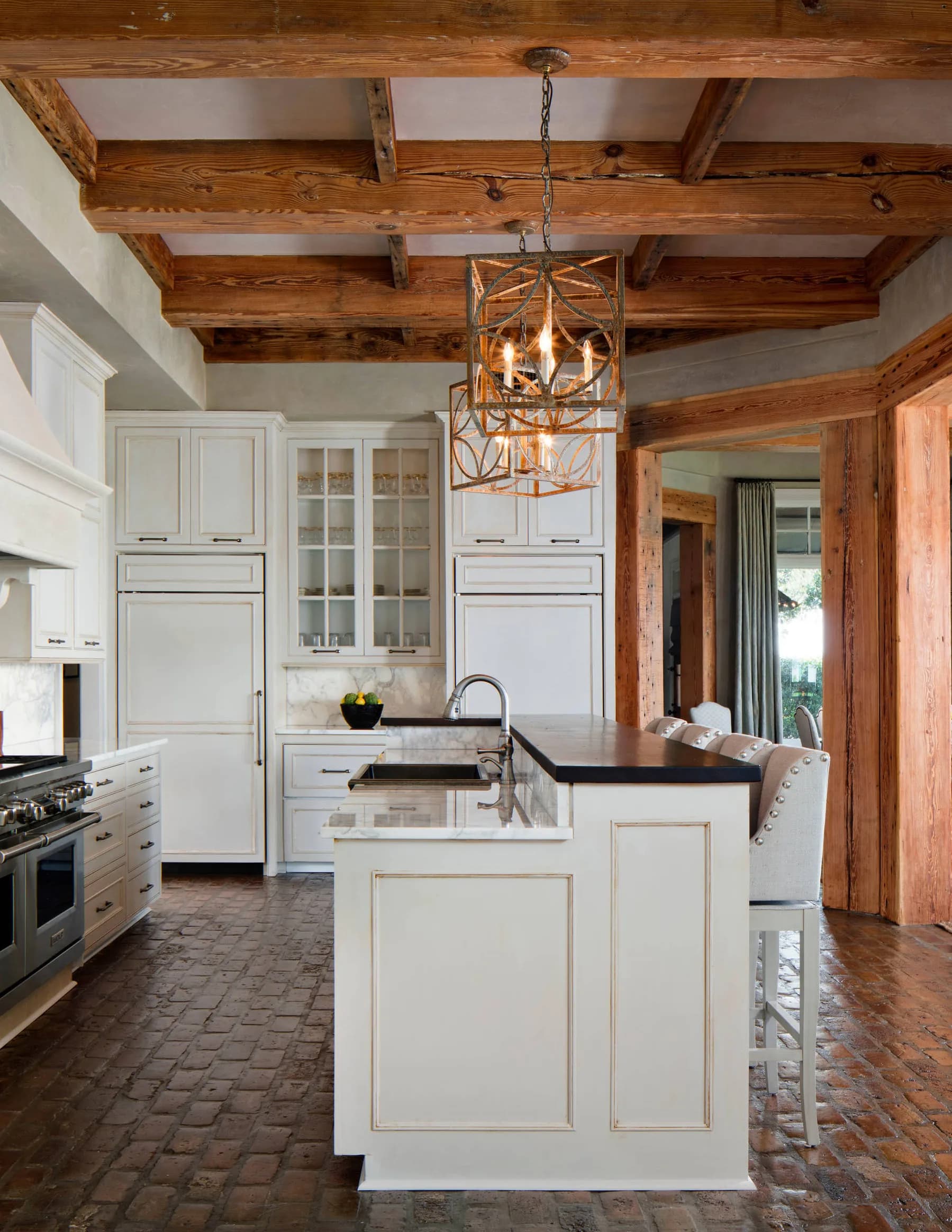 A kitchen under salvaged heart pine beams