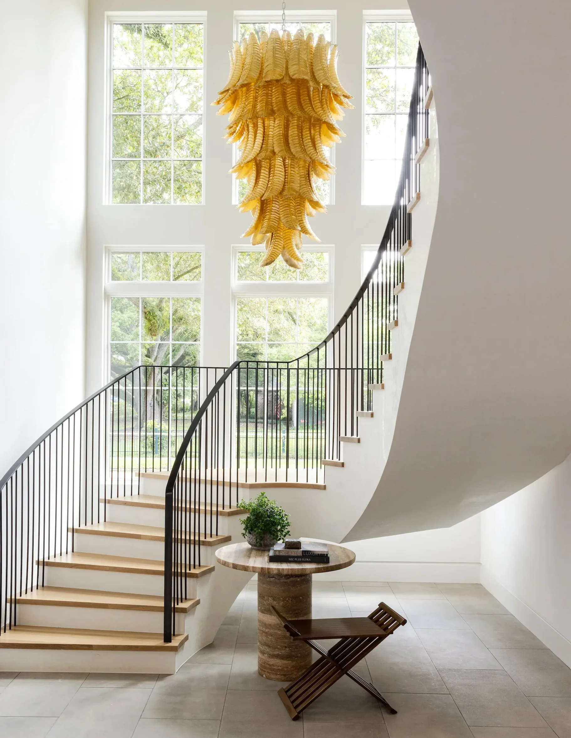 A curved stair in solid reclaimed oak with an iron balustrade