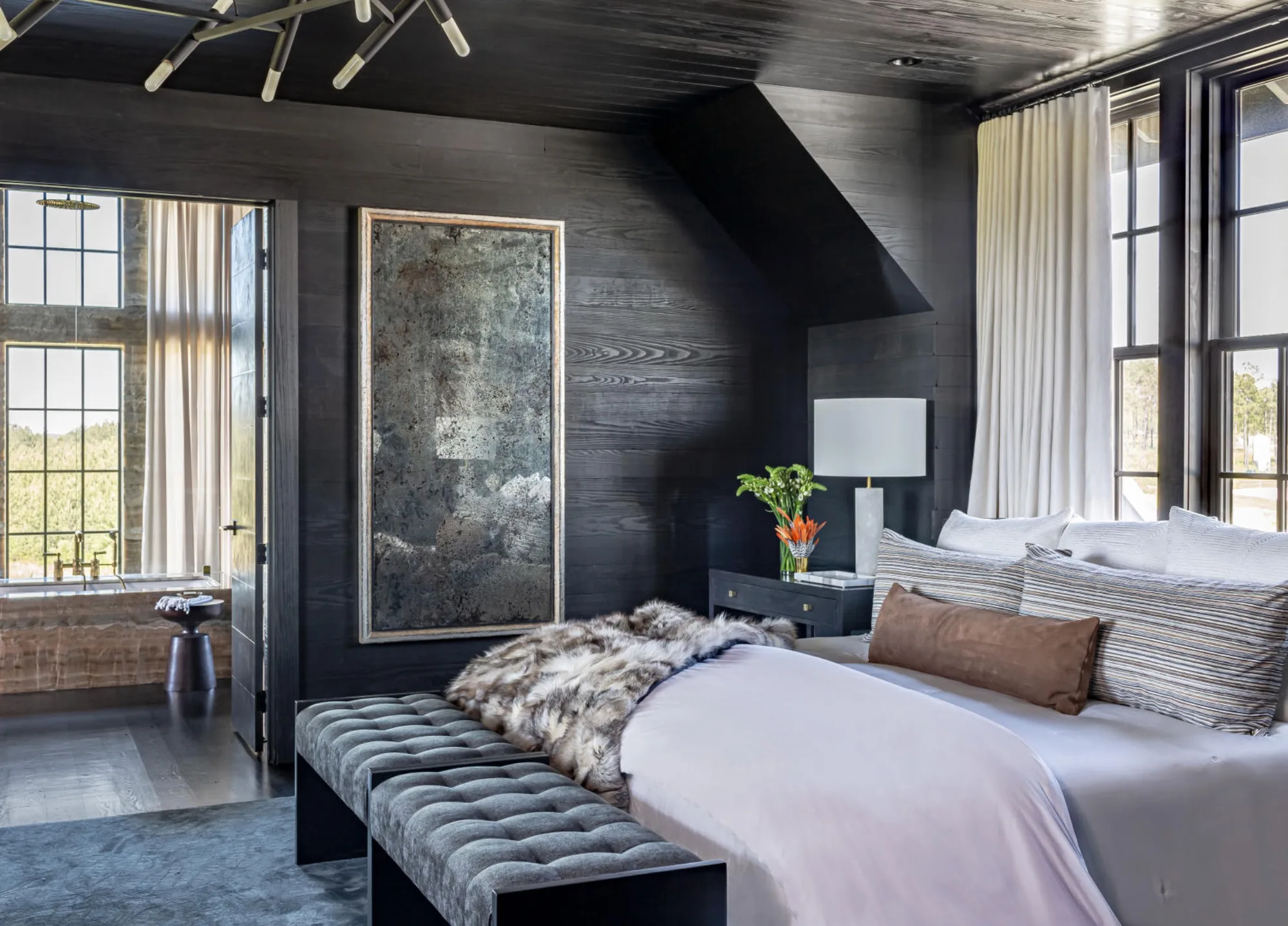 A bedroom under a graphite finished reclaimed ceiling