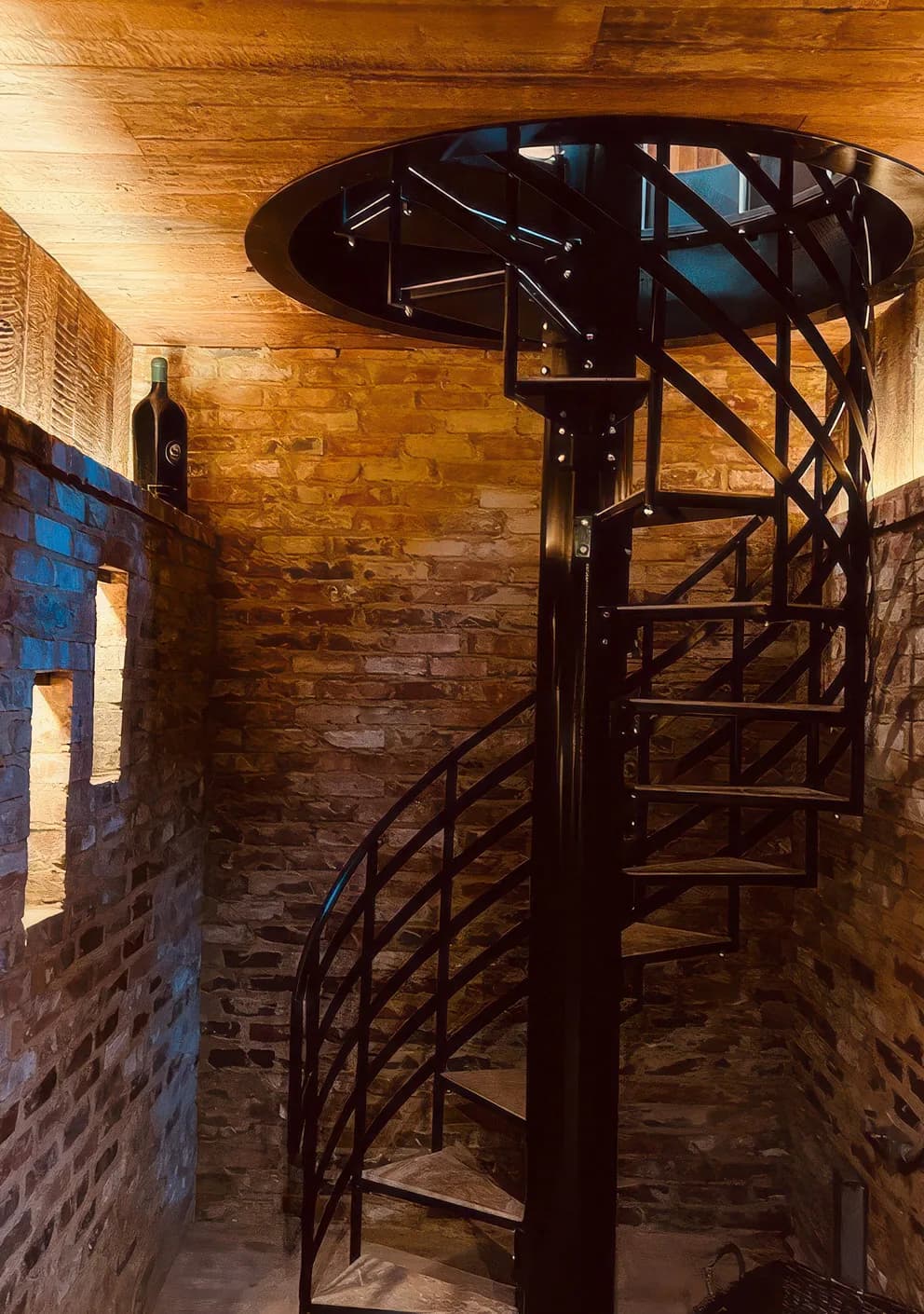 A compact spiral stair in timber and steel