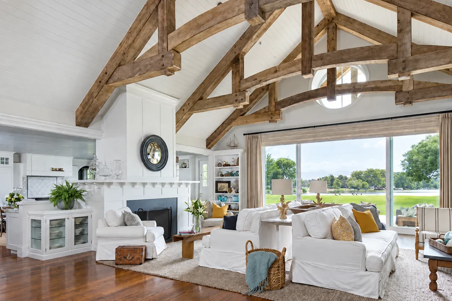 Reclaimed oak king post trusses across a white vaulted living room
