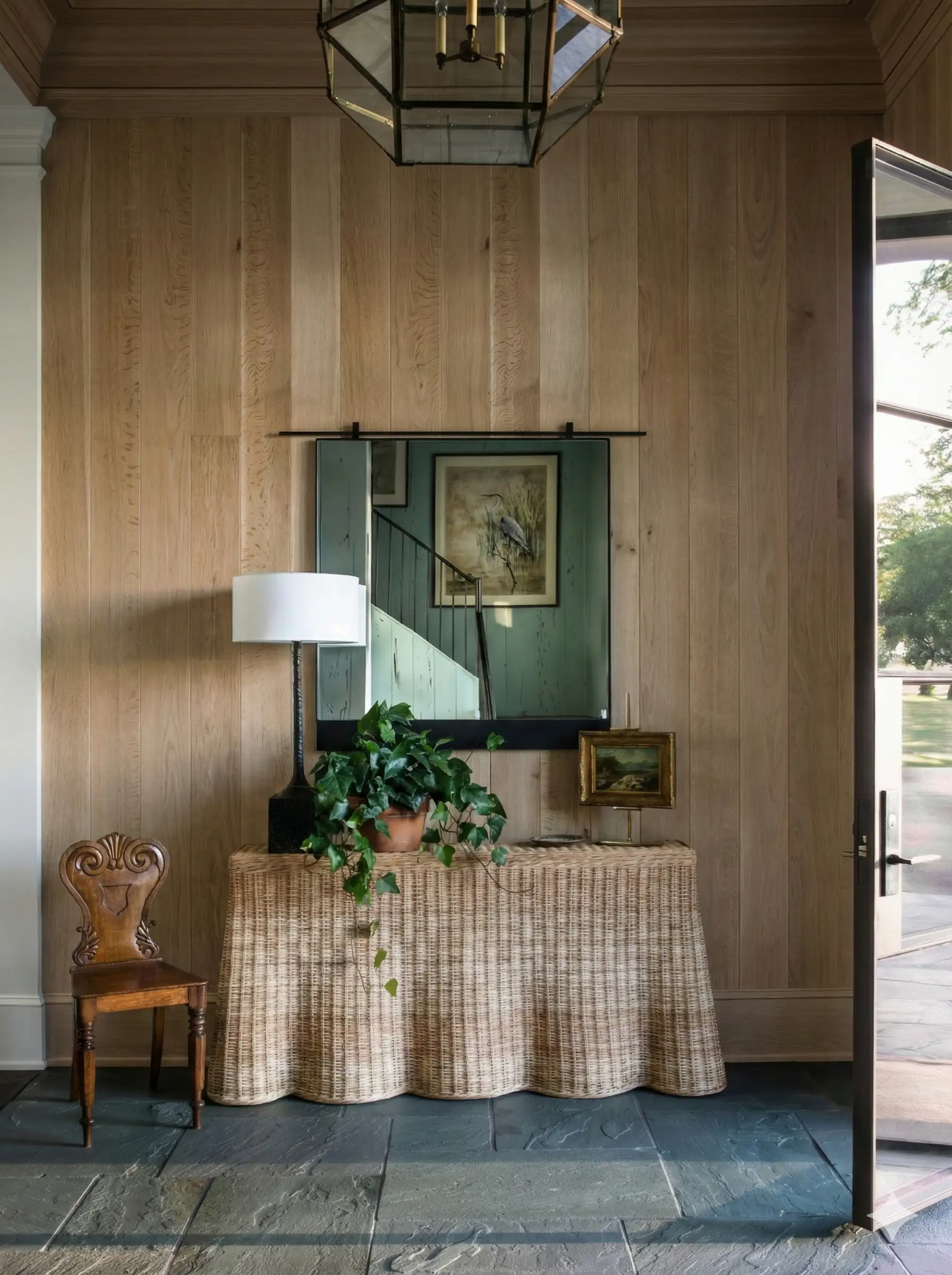 An entrance hall lined floor to ceiling in white oak panelling