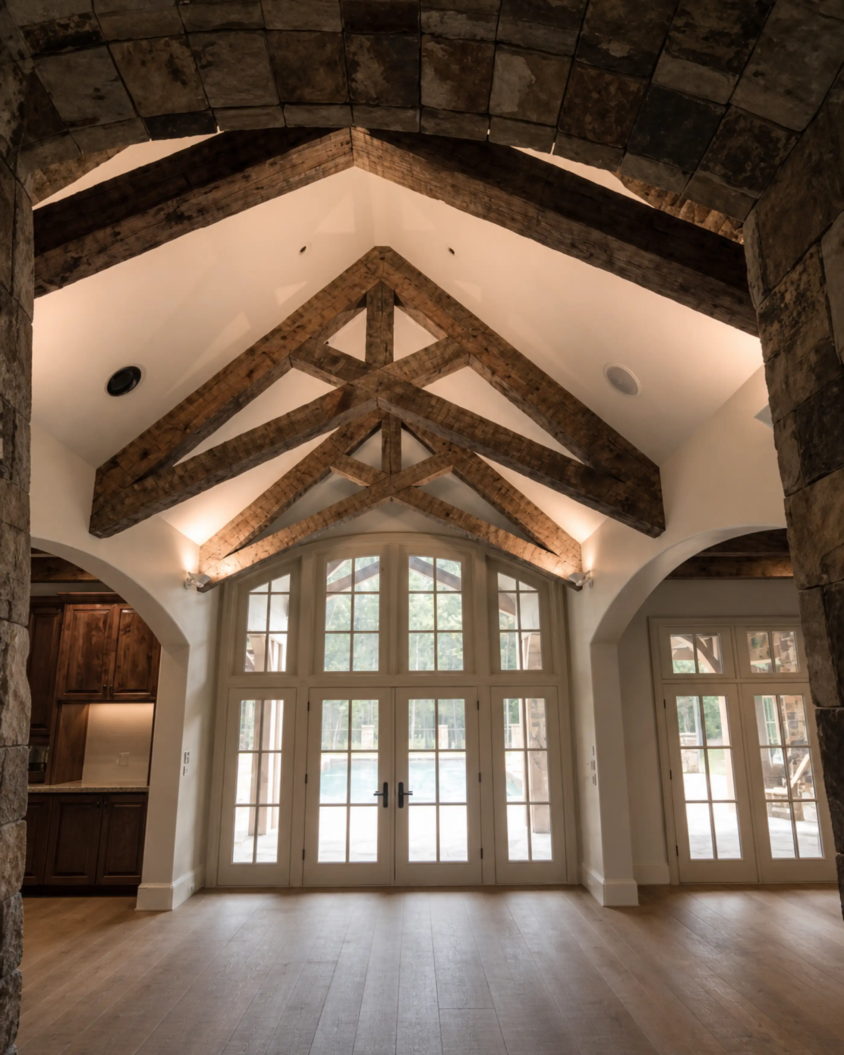 Hand hewn king post trusses over a vaulted great room