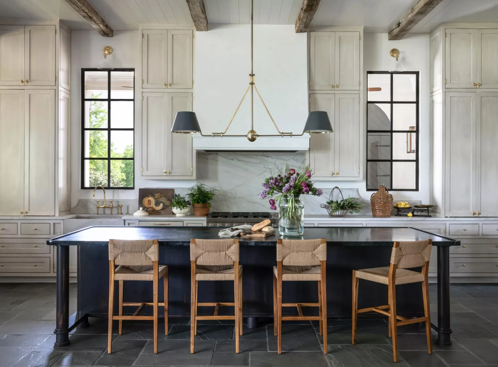 A kitchen under exposed cypress beams