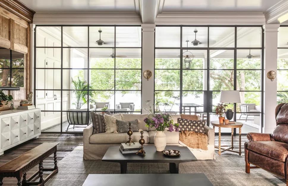A living room opening onto steel framed glazing